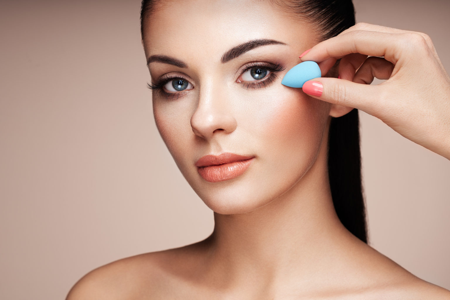 Makeup artist applies skintone